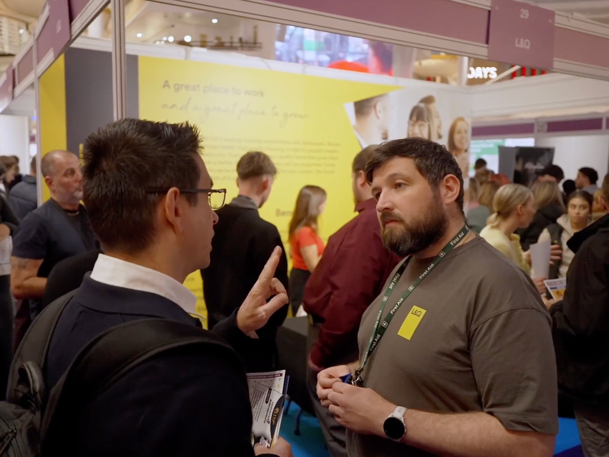 An employer and candidate in conversation at a stand at the Manchester Job Show